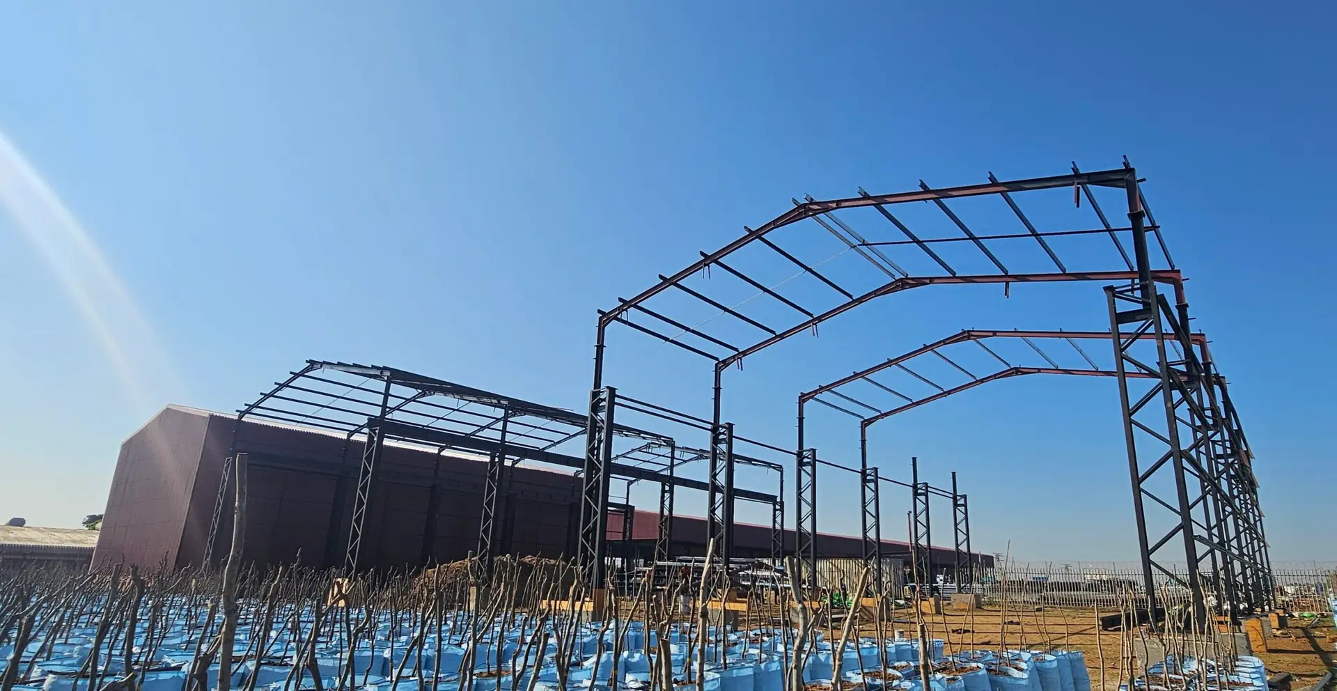 Completed factory with additional factory structures under erection